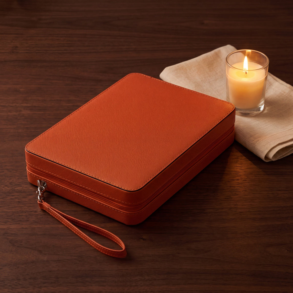 Compact Backgammon Deep Amber closed on a table, zipped case with wrist strap