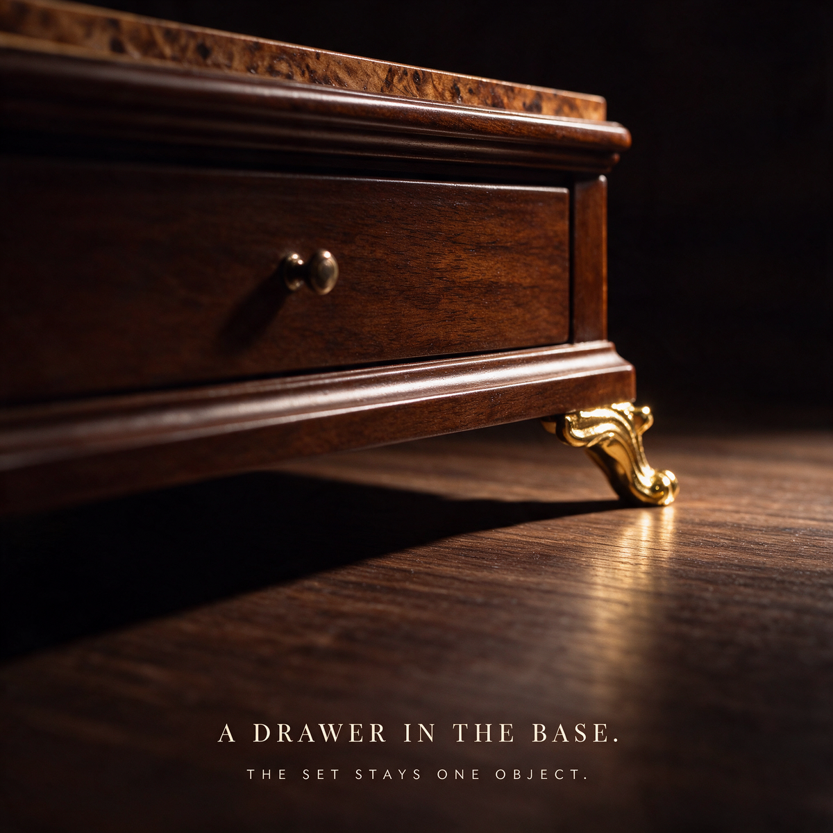 The drawer front and gilt cast foot on the moulded base of the cabinet