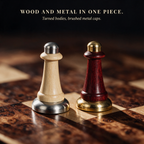 Close-up of chess pieces in turned wood with brushed gold and silver metal caps