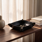 Folding valet tray on a walnut console table holding dice and a key