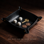 The tray holding dice, a brass key and two coins