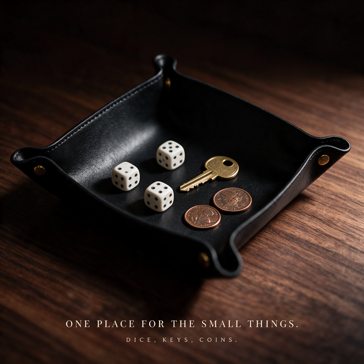 The tray holding dice, a brass key and two coins