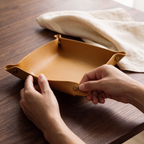Hands releasing a corner snap so the tray folds flat